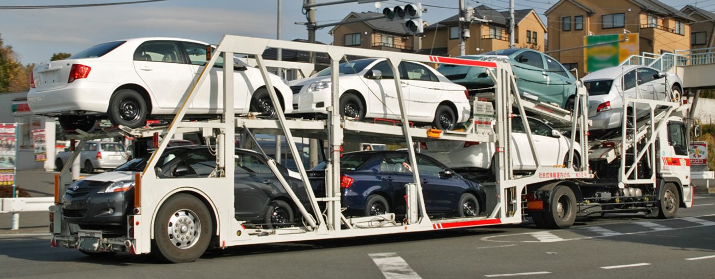 Cars loaded on a multi-deck open transport trailer