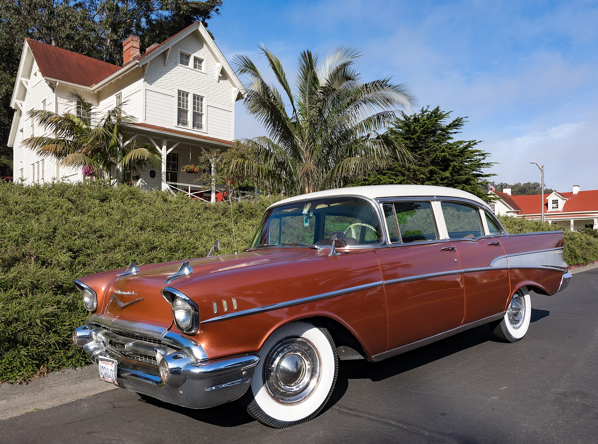 A copper and white 1957 Chevrolet Bel Air four-door sedan with whitewall tyres, parked on a street in the Presidio of San Francisco.